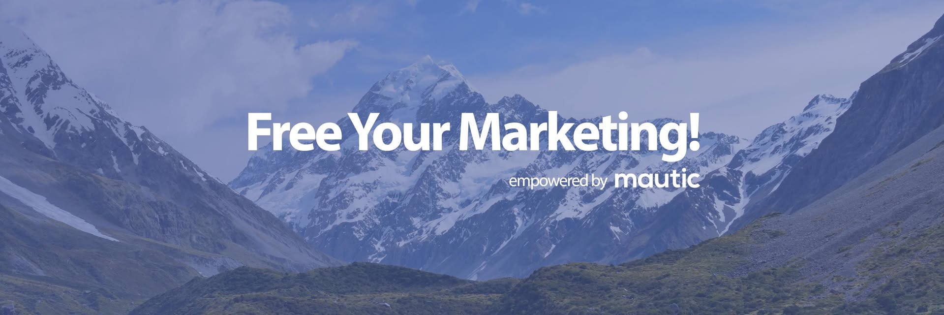 Image of mountains in the background with a purple transparent overlay and the words 'free your marketing! empowered by Mautic' in white text.