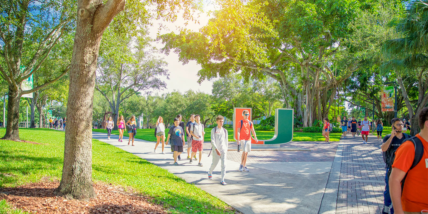 University of Miami students walking past the U statue on the Coral Gables campus